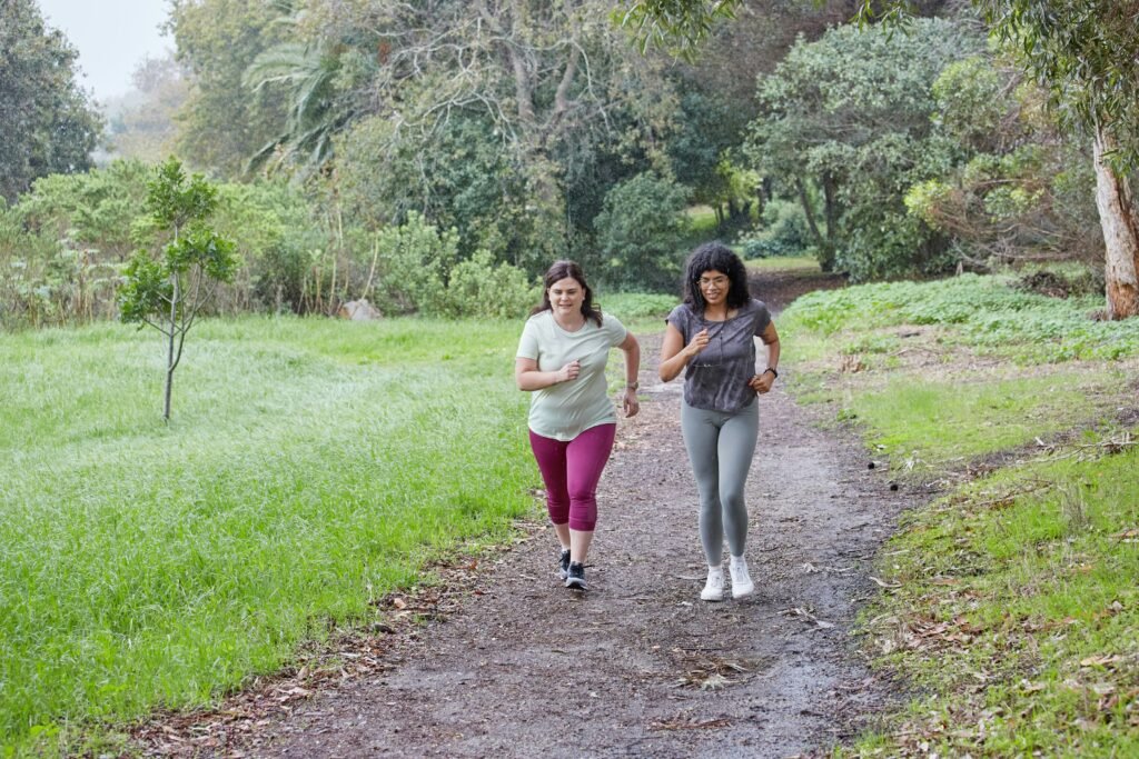 Two women are running together on a path.